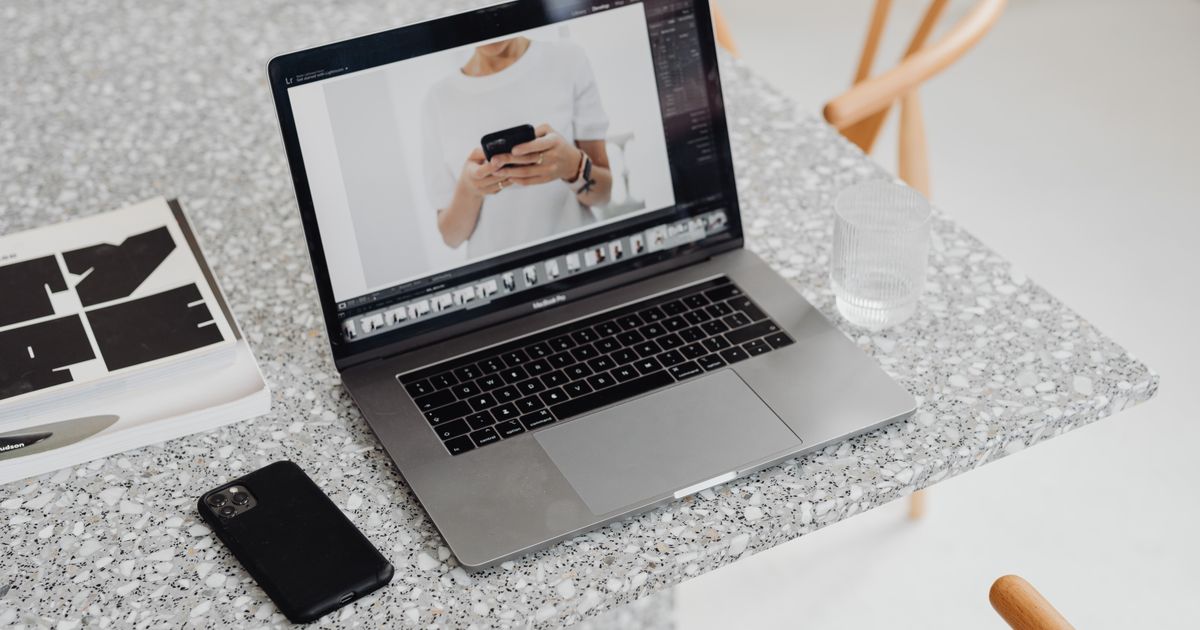 A traveller comparing hotel prices on a laptop and phone